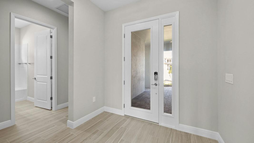 Spacious, unfurnished interior of a new home in SkySail Real Estate and Homes for Sale in Naples, FL - Neal Communities, Naples (Image 9).