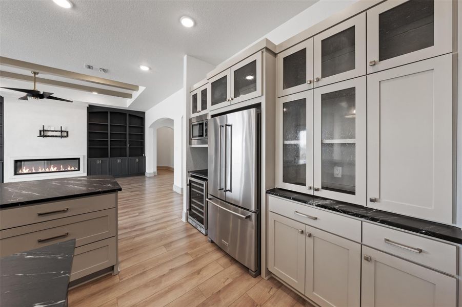 Kitchen featuring visible vents, arched walkways, ceiling fan, stainless steel appliances, and light wood-type flooring