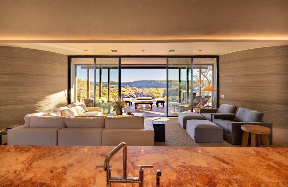Carpeted living room with a wall of windows, a mountain view, and wooden walls