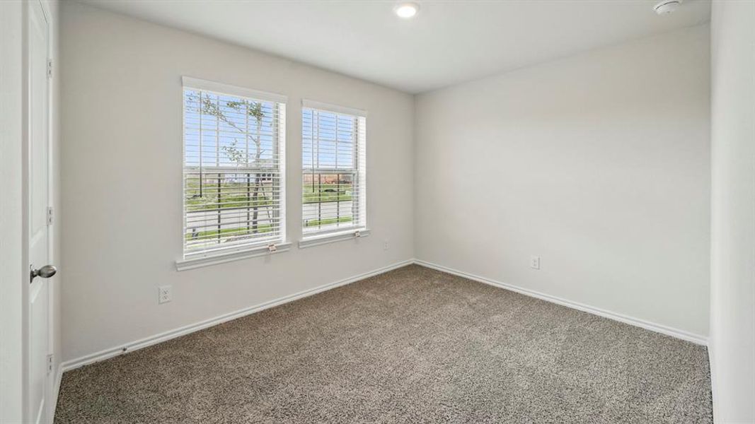Empty room with plenty of natural light and carpet flooring Empty room with plenty of natural light and carpet flooring