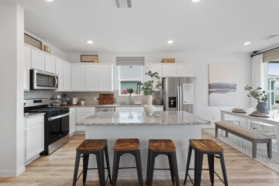 Every detail has been thoughtfully designed, from the state-of-the-art appliances that make meal prep a breeze, to the charming backsplash that adds a touch of personality.