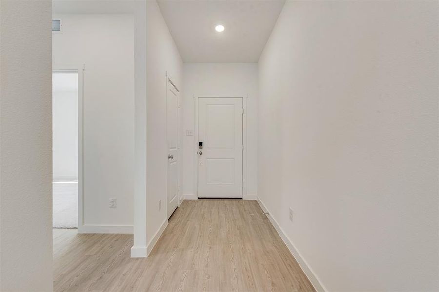 Hallway featuring light hardwood / wood-style flooring