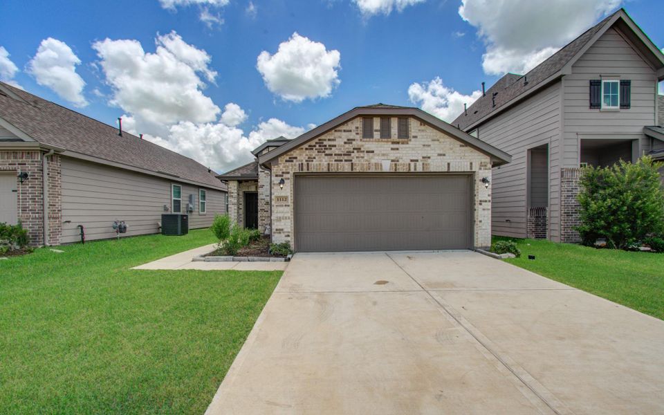This home features a modern brick exterior with a two-car garage. It's situated between similar houses, with a well-maintained lawn and a spacious driveway. The neighborhood appears serene and inviting. This home features a modern brick exterior with a two-car garage. It's situated between similar houses, with a well-maintained lawn and a spacious driveway. The neighborhood appears serene and inviting.