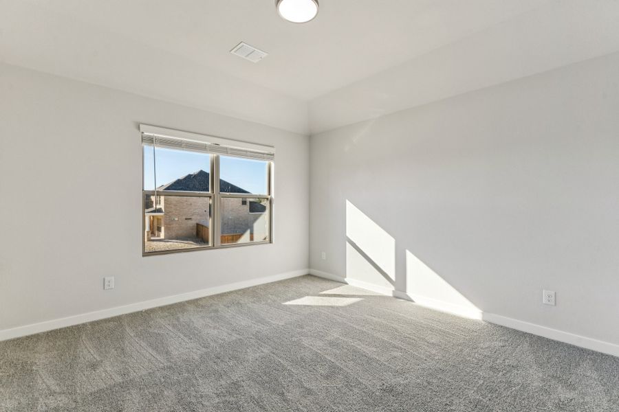 Bedroom in the Wimbledon home plan by Trophy Signature Homes – REPRESENTATIVE PHOTO Bedroom in the Wimbledon home plan by Trophy Signature Homes – REPRESENTATIVE PHOTO