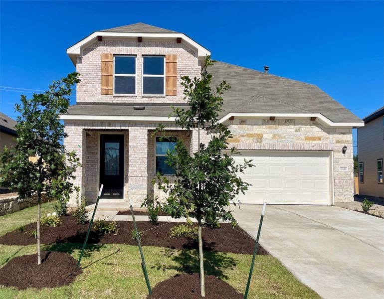 Front exterior of a new home in Covered Bridge, Hutto, TX, highlighting curb appeal (Image 2). Front exterior of a new home in Covered Bridge, Hutto, TX, highlighting curb appeal (Image 2).