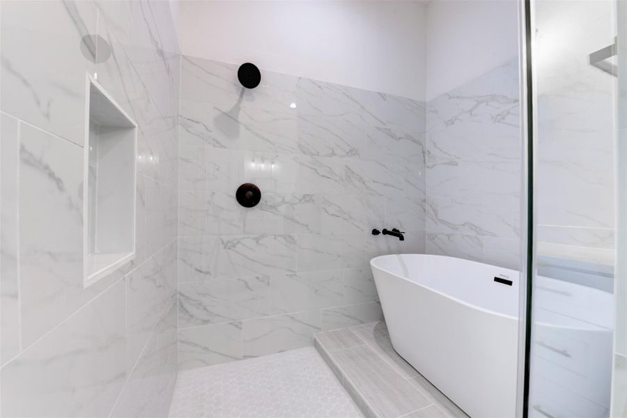 Thoughtfully designed primary bath showcasing a freestanding tub within the shower for a sleek, high-end feel.