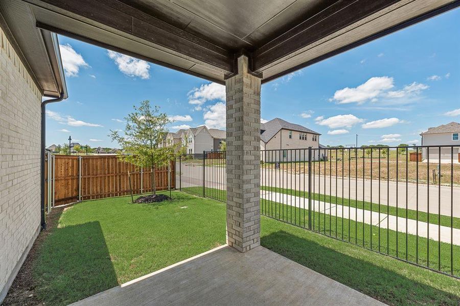 Fenced backyard with a patio area and a residential view Fenced backyard with a patio area and a residential view