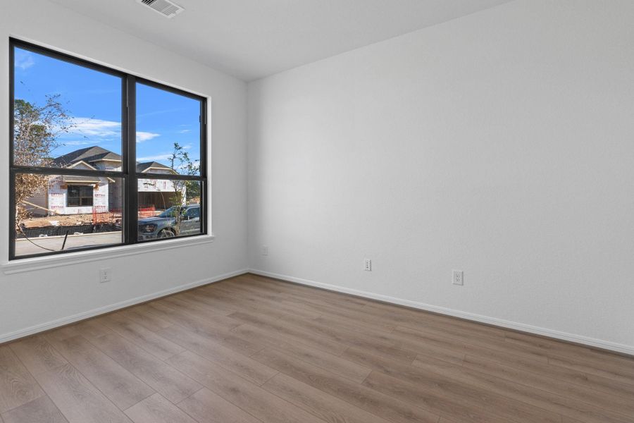 The home office features beautiful floors, large windows that give a fresh feel, this space promotes focus and creativity.