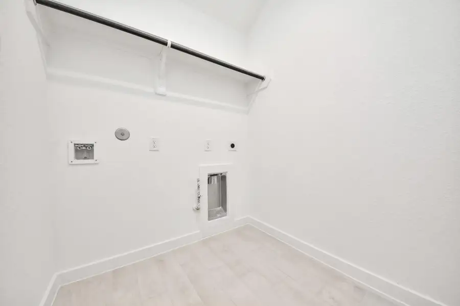 A perfect blend of functionality and comfort. Capture the essence of easy living with a first-floor laundry room, thoughtfully equipped with shelving for effortless organization. Both electric and gas connections available.