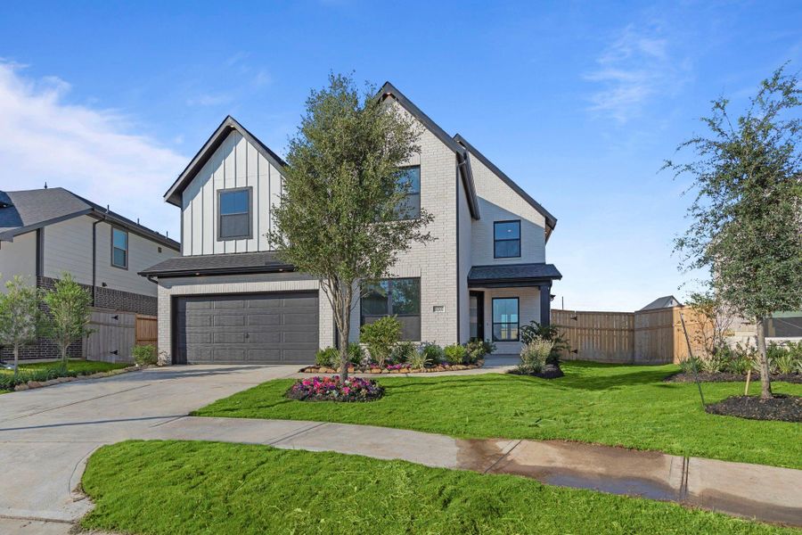 Front exterior of a new home in Cross Creek West 50', Fulshear, TX, highlighting curb appeal (Image 1). Front exterior of a new home in Cross Creek West 50', Fulshear, TX, highlighting curb appeal (Image 1).
