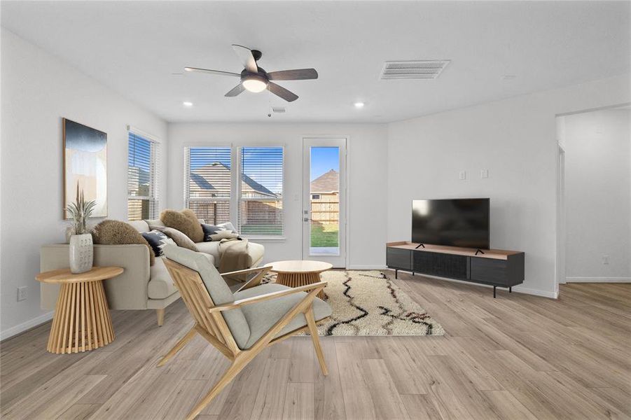 This light and bright spacious family room is the perfect layout for entertaining or just relaxing. Whether it's simply a night in or entertaining family and friends, this home has ample open space for everyone to enjoy! Featuring vinyl plank flooring, large windows, high ceilings with ceiling fan, recessed lighting, and wonderful access to your gorgeous kitchen.