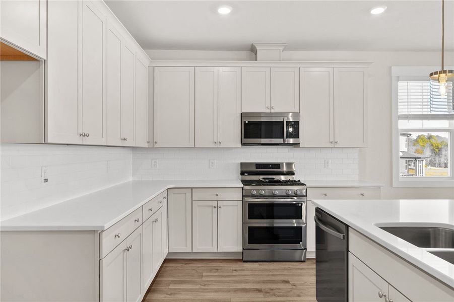 This modern kitchen features pristine quartz count