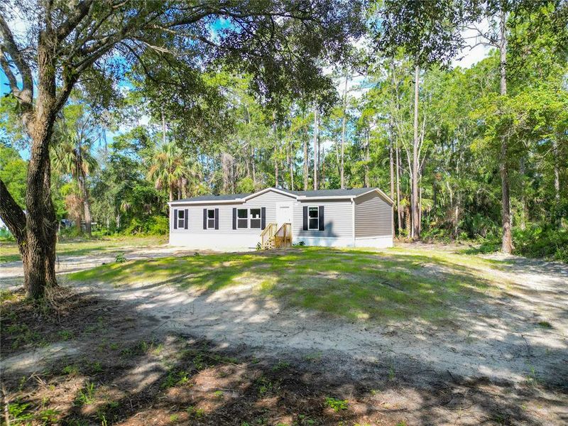 Front exterior of a new home in , Inglis, FL, highlighting curb appeal (Image 20).