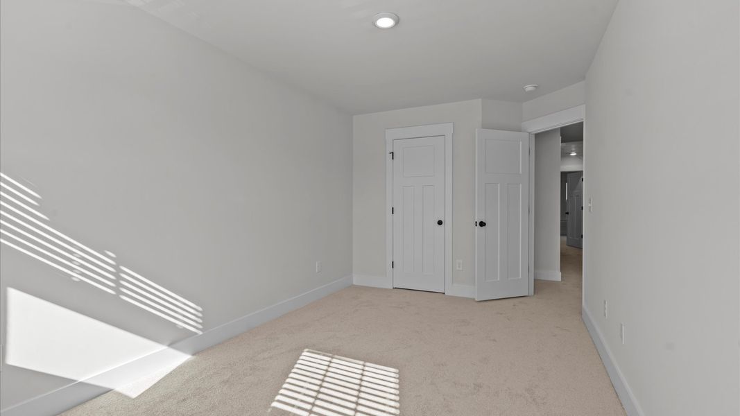 First-class secondary bedroom with comfortable carpeted flooring and generous closet space at Gresham Station