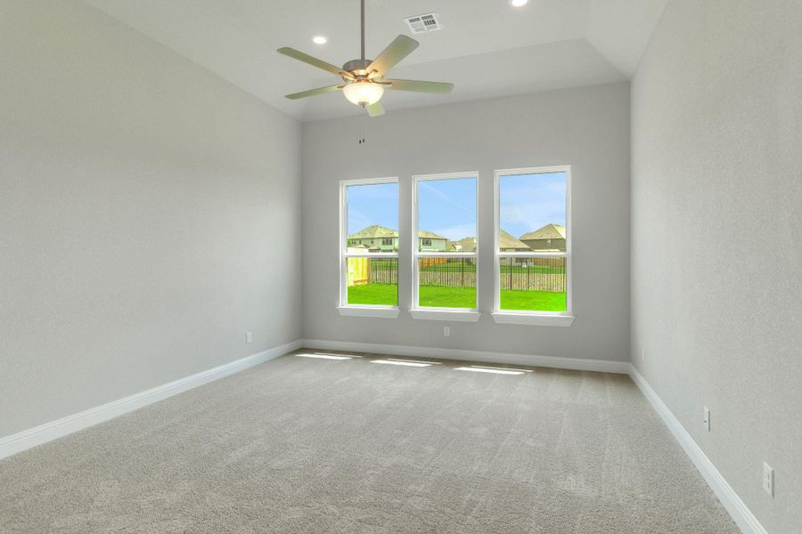 Carpeted empty room featuring visible vents, a ceiling fan, baseboards, and recessed lighting