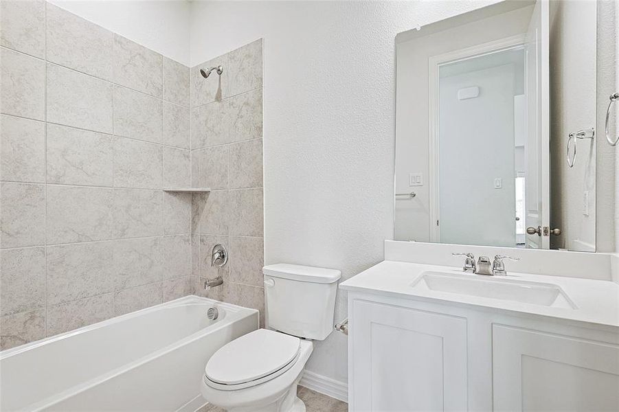 Full bath with vanity, bathtub / shower combination, and a textured wall