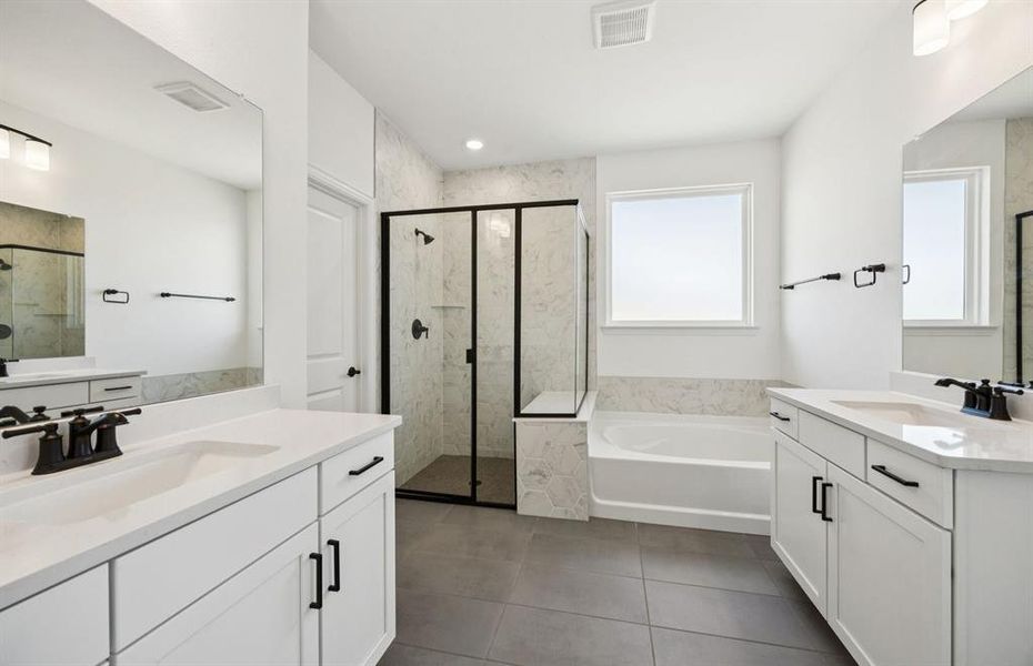 Elegant owner's bathroom with dual vanity and oversized shower*real home pictured