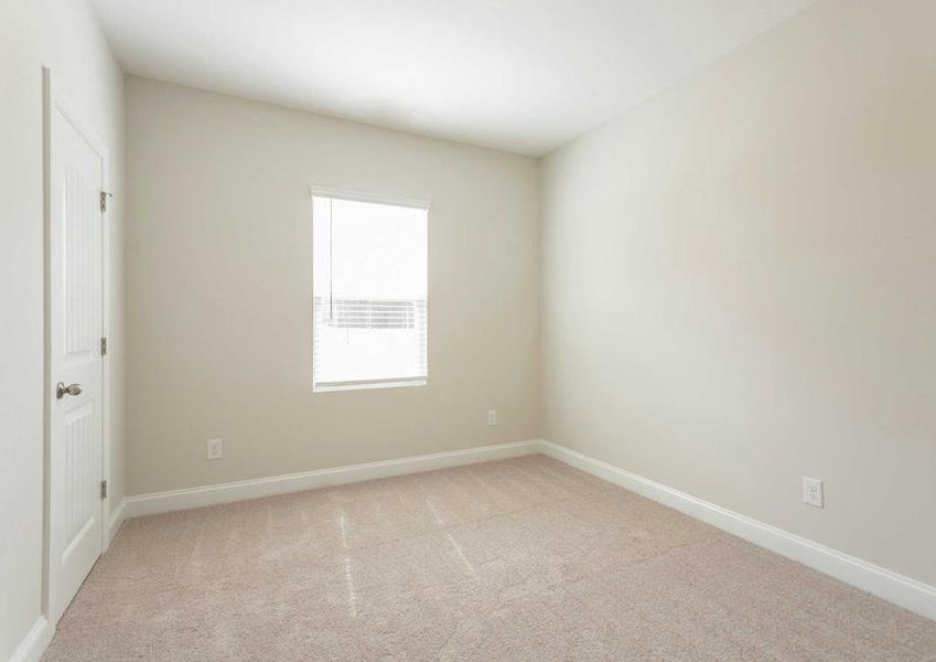 Allatoona bedroom with tan carpets, white trim, and off white walls