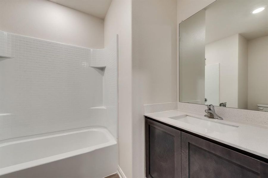 Full bathroom with toilet, shower / washtub combination, and vanity