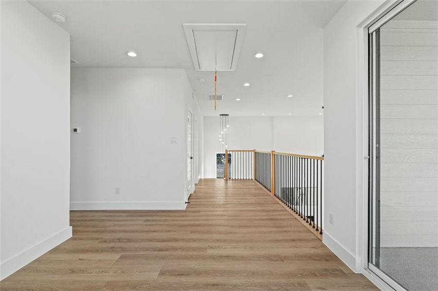 Hall featuring light wood-style flooring and recessed lighting
