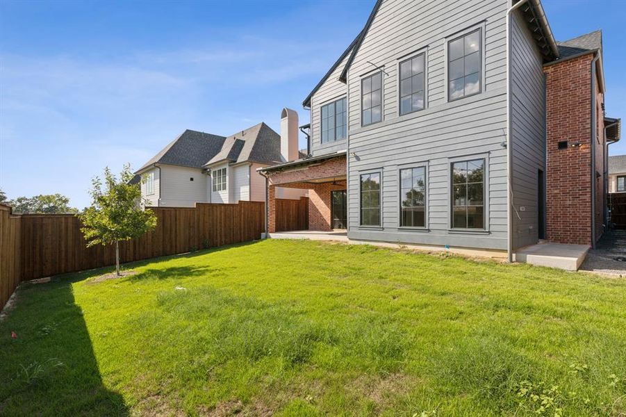 Rear view of house featuring a patio area and a yard