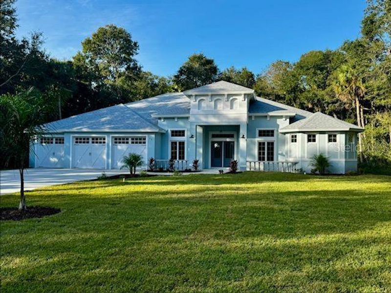 Front exterior of a new home in , Flagler Beach, FL, highlighting curb appeal (Image 1). Front exterior of a new home in , Flagler Beach, FL, highlighting curb appeal (Image 1).