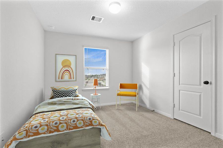 Secondary bedroom features plush carpet, neutral paint, lighting, window with privacy blinds and ample sized closet space.