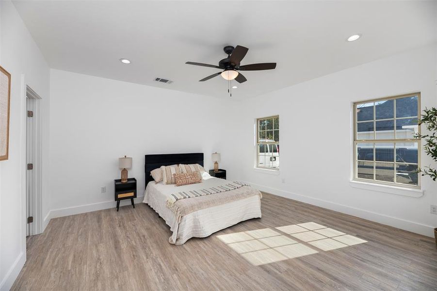 Bedroom with light wood-style flooring, recessed lighting, and ceiling fan Bedroom with light wood-style flooring, recessed lighting, and ceiling fan