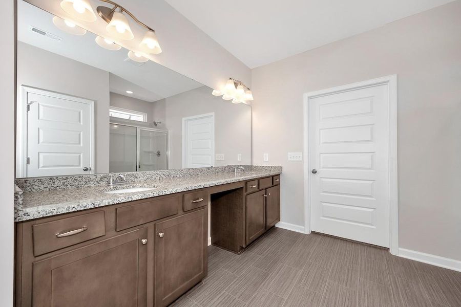 The Avery- Primary Bathroom with Dual Vanities and Walk-In Shower. Home under construction. Sample floor plan photo used for illustrative purposes only. Upgrades, selections options, and colors will vary.