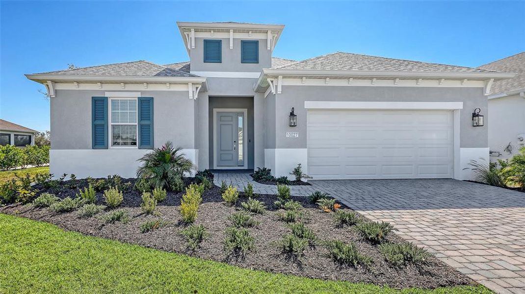 Front exterior of a new home in Wildleaf, Parrish, FL, highlighting curb appeal (Image 2). Front exterior of a new home in Wildleaf, Parrish, FL, highlighting curb appeal (Image 2).