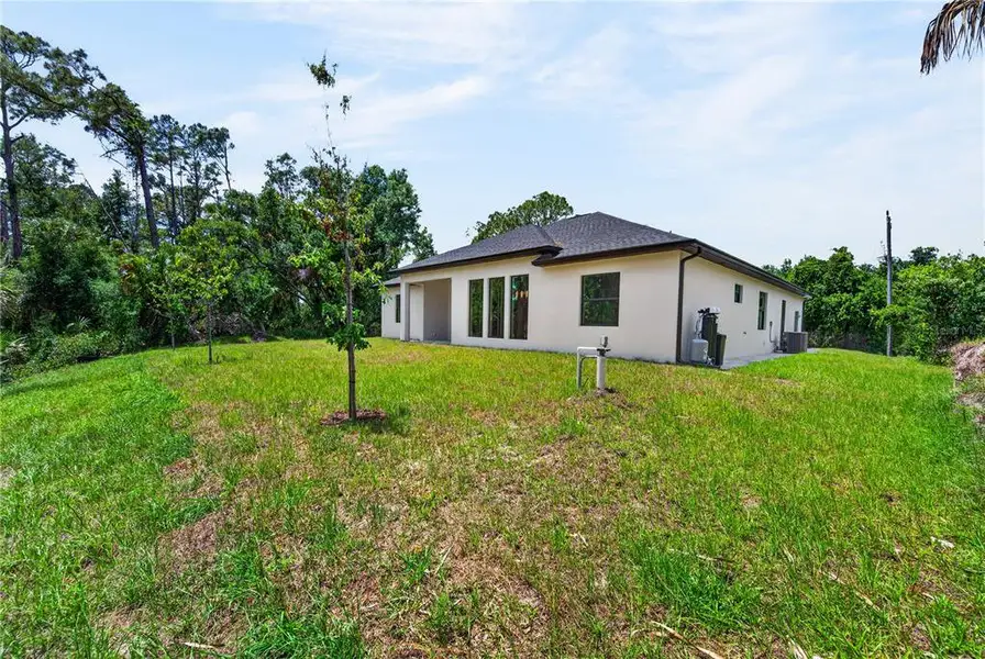 Exterior details and patio area of a home in , North Port (Image 36).