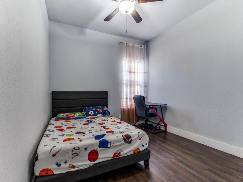 Bedroom featuring dark wood-type flooring and ceiling fan Bedroom featuring dark wood-type flooring and ceiling fan