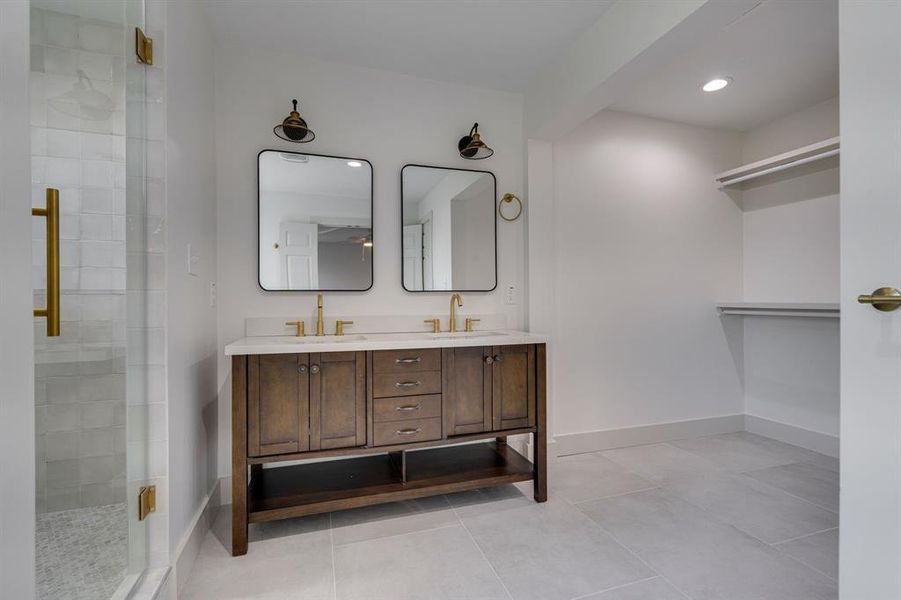 Bathroom featuring vanity, walk in shower, and tile patterned floors