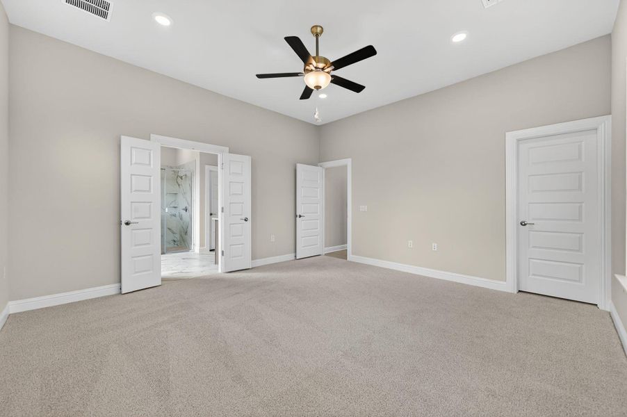 Unfurnished bedroom with light carpet, ceiling fan, and recessed lighting