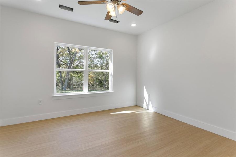 Empty room featuring light hardwood / wood-style floors and ceiling fan