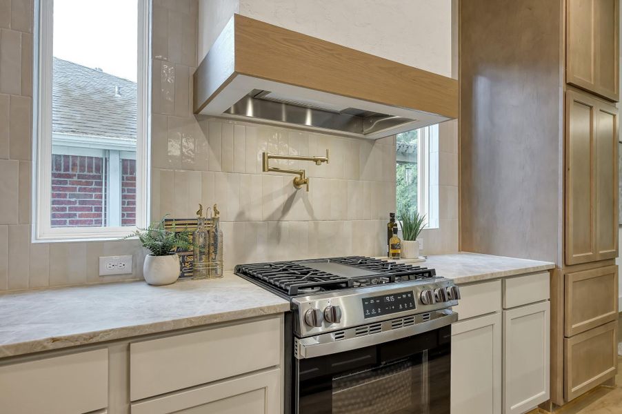 Custom vent hood, pot filler and backsplash to the ceiling. Custom vent hood, pot filler and backsplash to the ceiling.