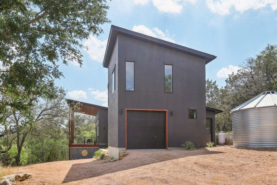 View of side of home with driveway, an attached garage, and stucco siding View of side of home with driveway, an attached garage, and stucco siding
