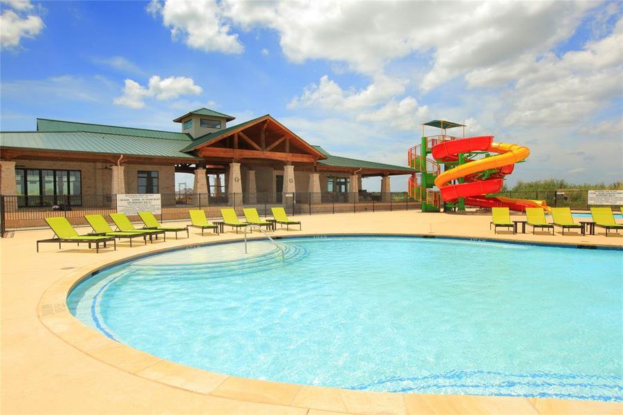 View of pool with a patio area and a water slide