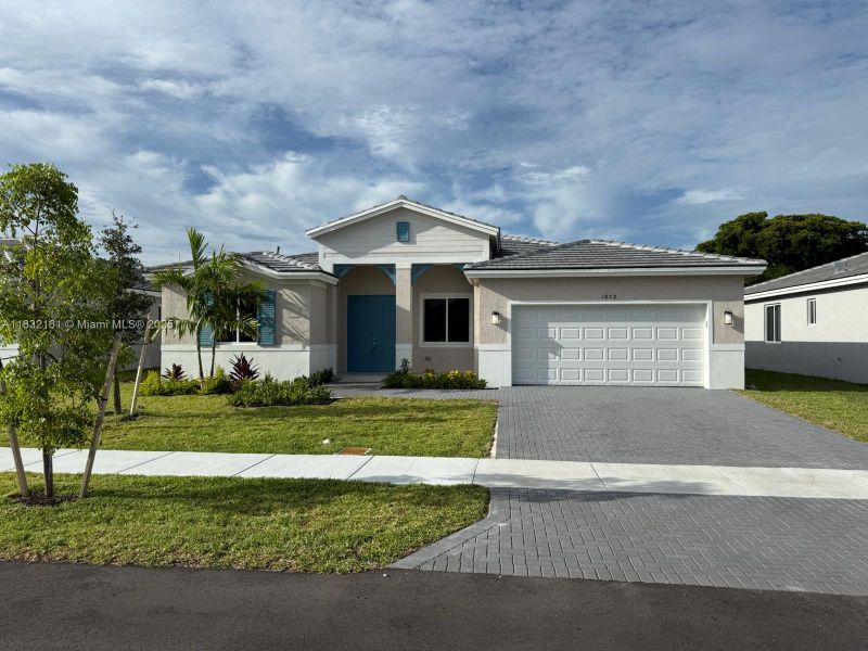 Front exterior of a new home in , Homestead, FL, highlighting curb appeal (Image 1). Front exterior of a new home in , Homestead, FL, highlighting curb appeal (Image 1).