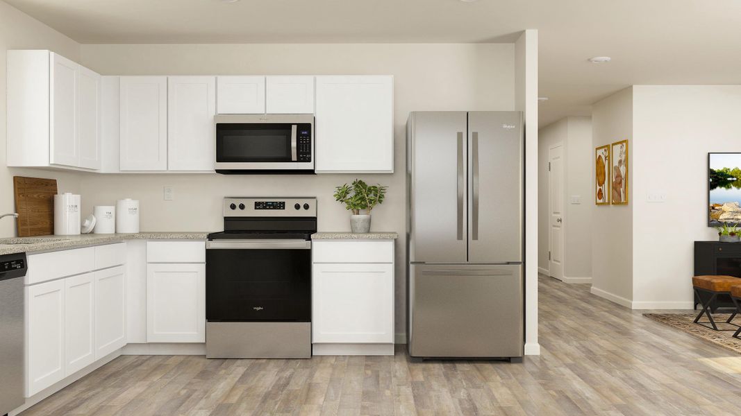 A kitchen with white cabinets.