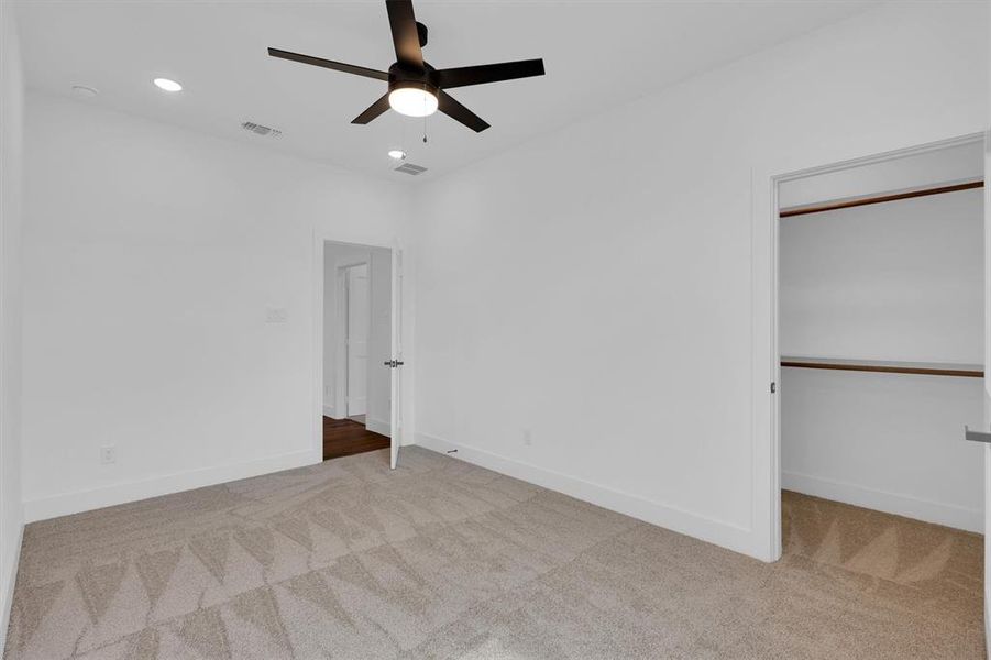 Unfurnished bedroom featuring carpet flooring, a ceiling fan, and recessed lighting Unfurnished bedroom featuring carpet flooring, a ceiling fan, and recessed lighting