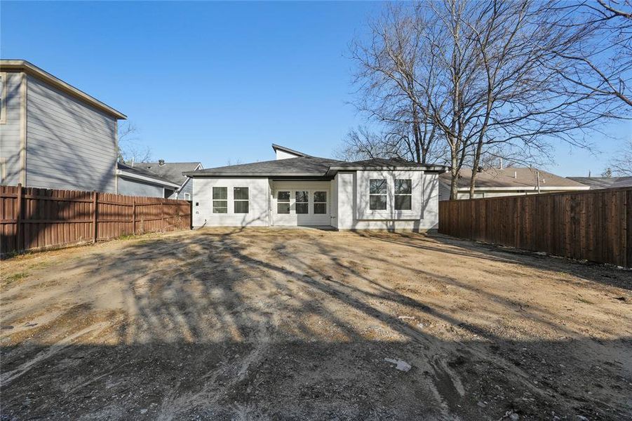 Back of house with a fenced backyard