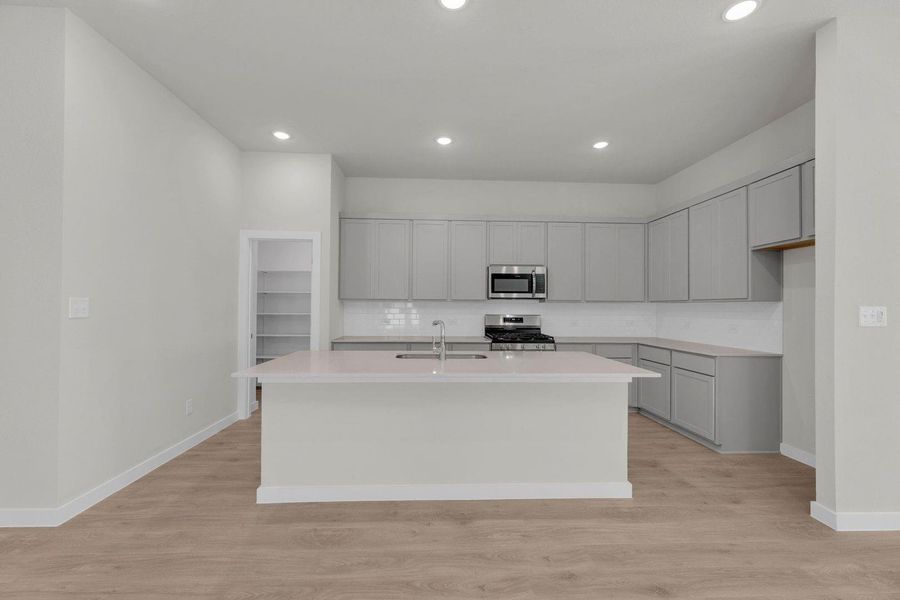 Kitchen in the Pecos home plan by Trophy Signature Homes – REPRESENTATIVE PHOTO