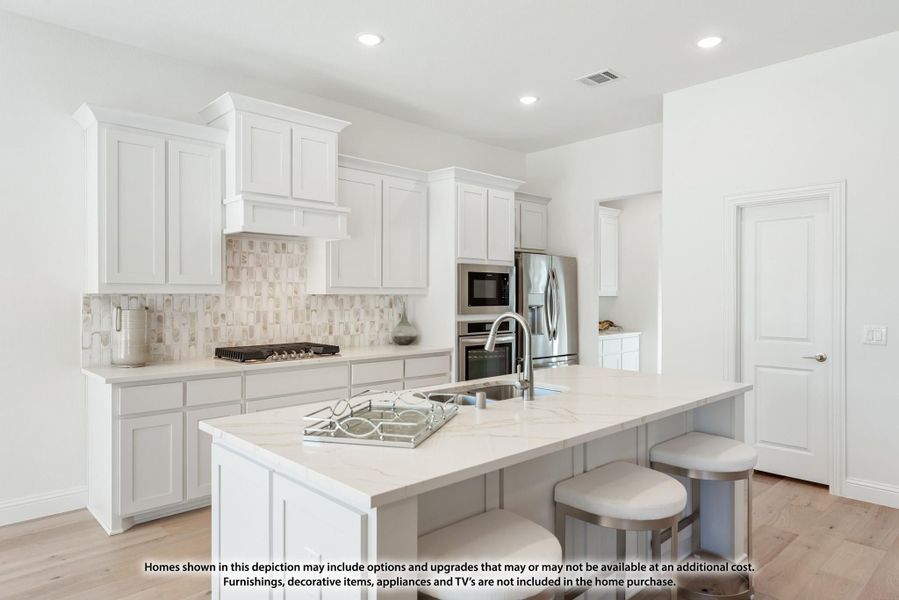 White kitchen with large island, quartz countertops, tile backsplash, and stainless steel appliances White kitchen with large island, quartz countertops, tile backsplash, and stainless steel appliances