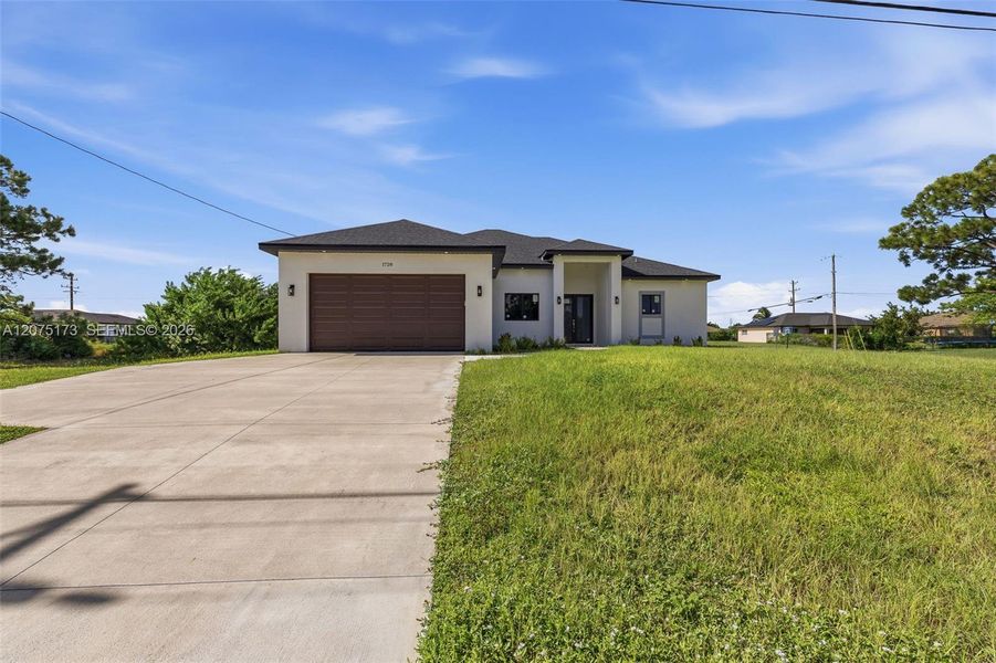 Front exterior of a new home in , Cape Coral, FL, highlighting curb appeal (Image 23).