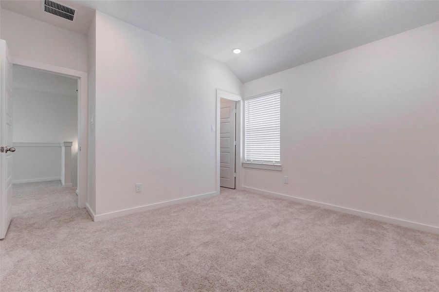 Bright secondary bedroom with neutral carpet, clean white walls, recessed lighting, and a window bringing in natural light. The room offers a comfortable layout with easy access to the nearby hallway, making it a great option for a guest bedroom, child’s room, home office, or quiet personal retreat. Bright secondary bedroom with neutral carpet, clean white walls, recessed lighting, and a window bringing in natural light. The room offers a comfortable layout with easy access to the nearby hallway, making it a great option for a guest bedroom, child’s room, home office, or quiet personal retreat.