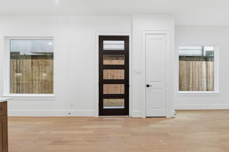 Bright and spacious first-floorliving with beautiful wood flooring,designer finishes, and impressivewood-framed front door creates astunning first impression. (Photo of a previous build, similar finishes.)