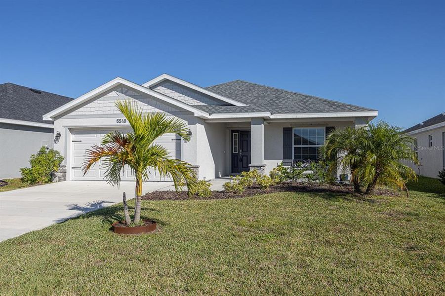 Front exterior of a new home in , Parrish, FL, highlighting curb appeal (Image 16).