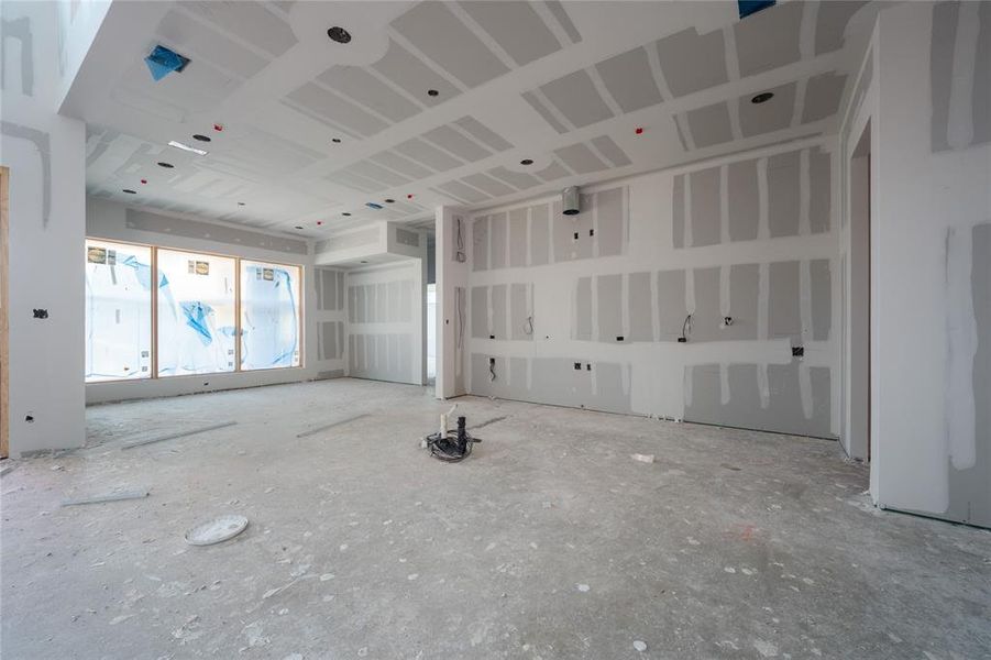 View of kitchen, dining space, and floor-to-ceiling wine storage.