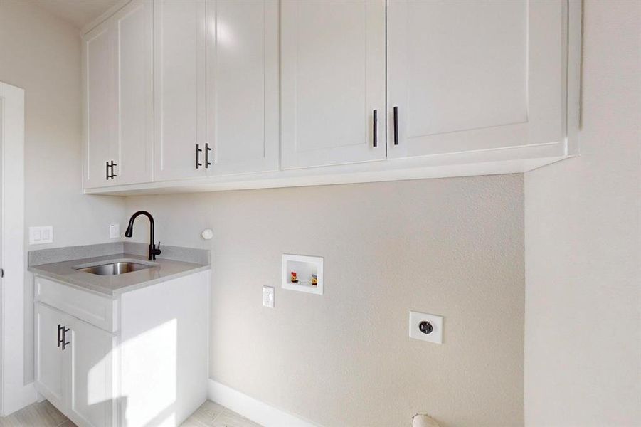 Laundry area featuring washer hookup, cabinet space, hookup for an electric dryer, and a sink